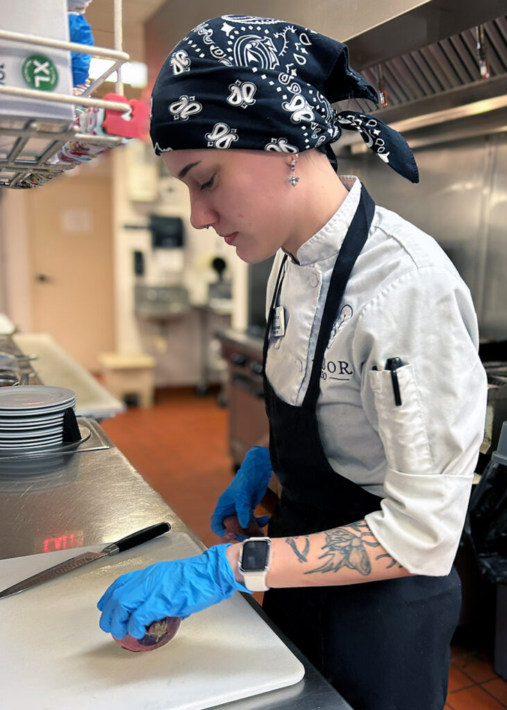 Culinary team member chops fresh ingredients for a chef-prepared meal at The KentRidge Senior Living.