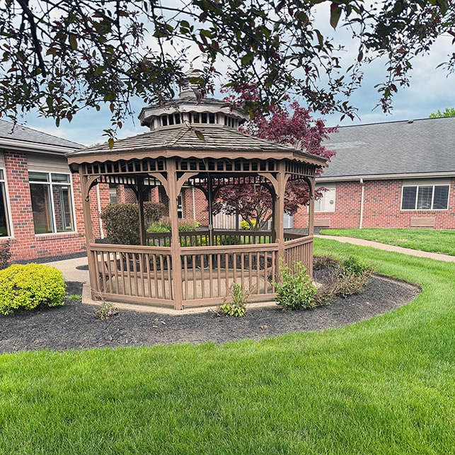 A picturesque gazebo in the landscaped grounds at The KentRidge senior living.